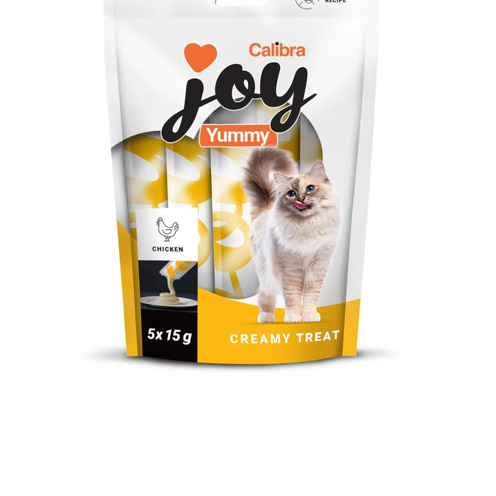 A stand-up pouch of Calibra Joy Yummy Creamy Treat cat food, 5x15g. The packaging is primarily white with a yellow bottom section, featuring a photo of a fluffy cat on the front, along with a chicken icon and a small sample of the creamy treat.