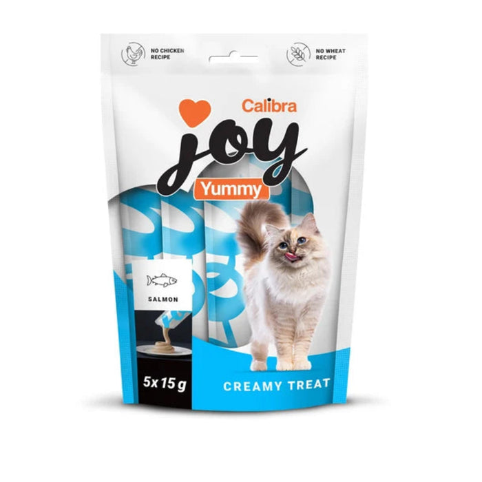 A stand-up pouch of Calibra Joy Yummy cat treats, 5x15g, featuring a white and blue design with a photo of a fluffy white cat on the front.