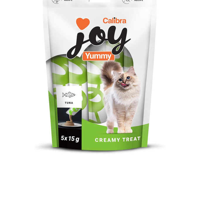 A stand-up pouch of Calibra Joy Yummy Creamy Treat for cats, featuring a white and green design with an image of a fluffy cat and a tuna icon, set against a plain white background.